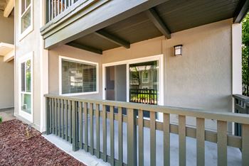 a porch of a house with a wooden railing  at Pleasanton Glen Apartments, Pleasanton, 94566